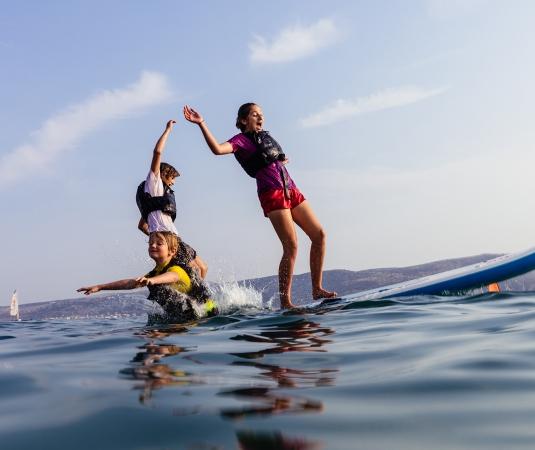 children playing on a paddle board